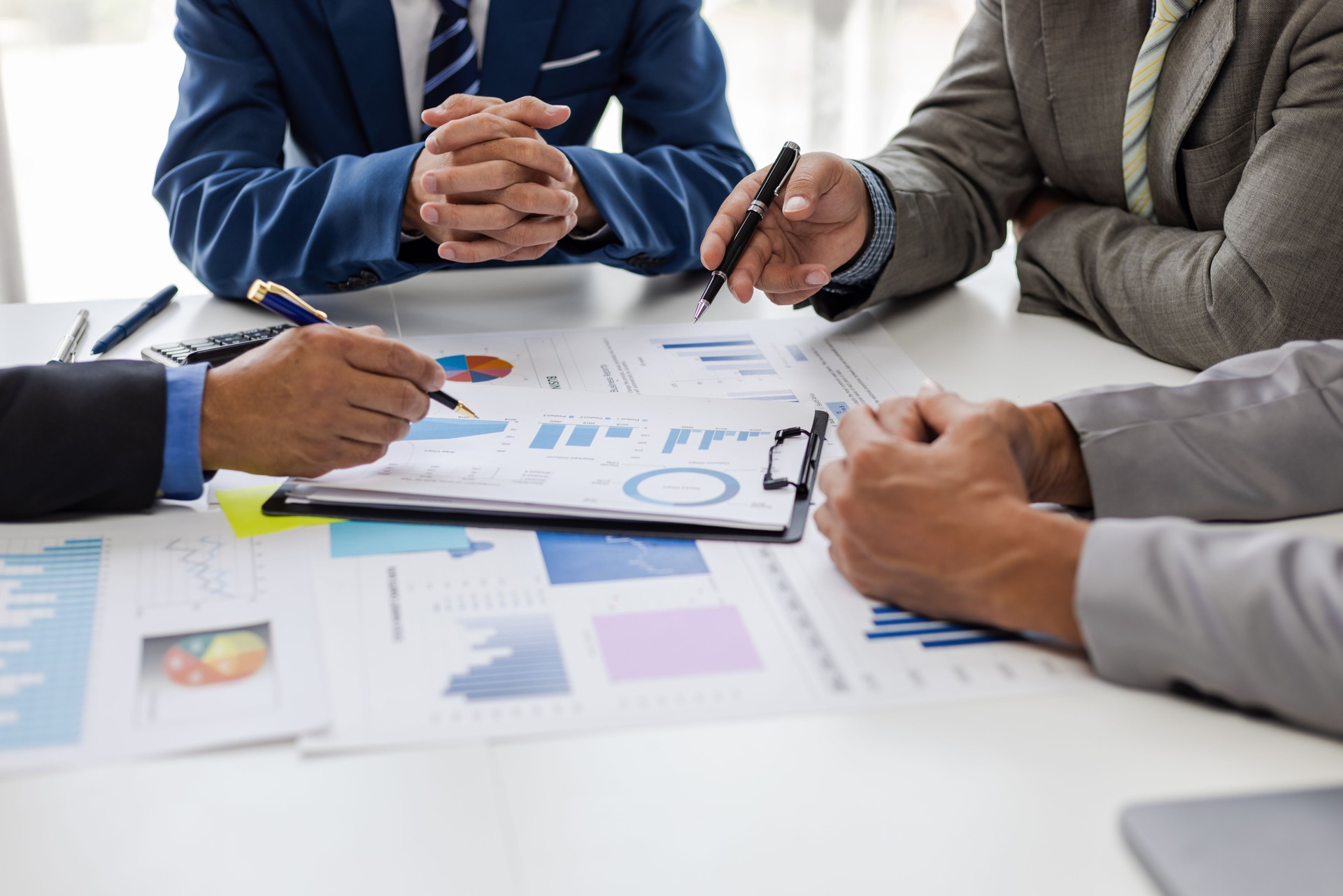 Business team analyzing chart and graph. Businesspeople corporate meeting, reviewing data financial report and marketing research. Discussing market situation analysis and financial planning.